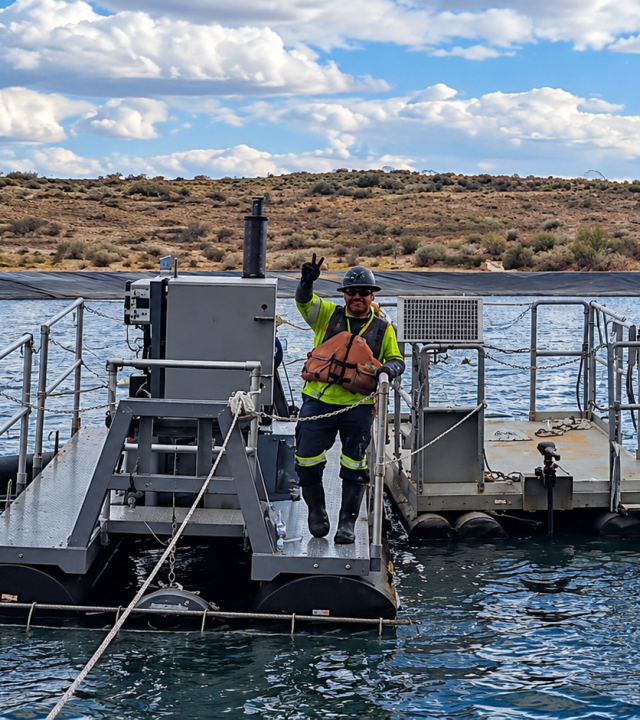 Smiling Worker on Floating Dredge Platform